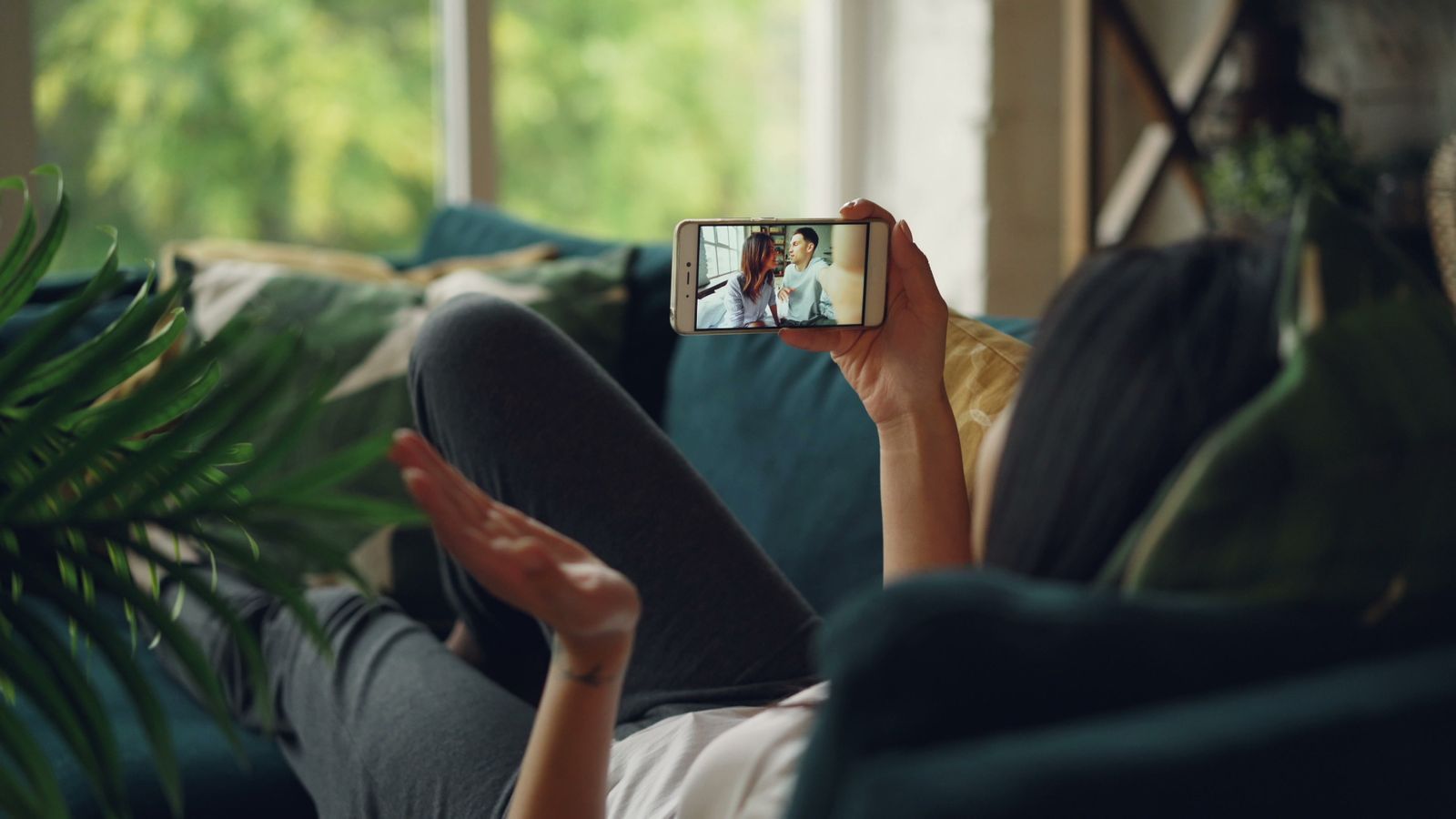 Patient using telehealth from home on a couch