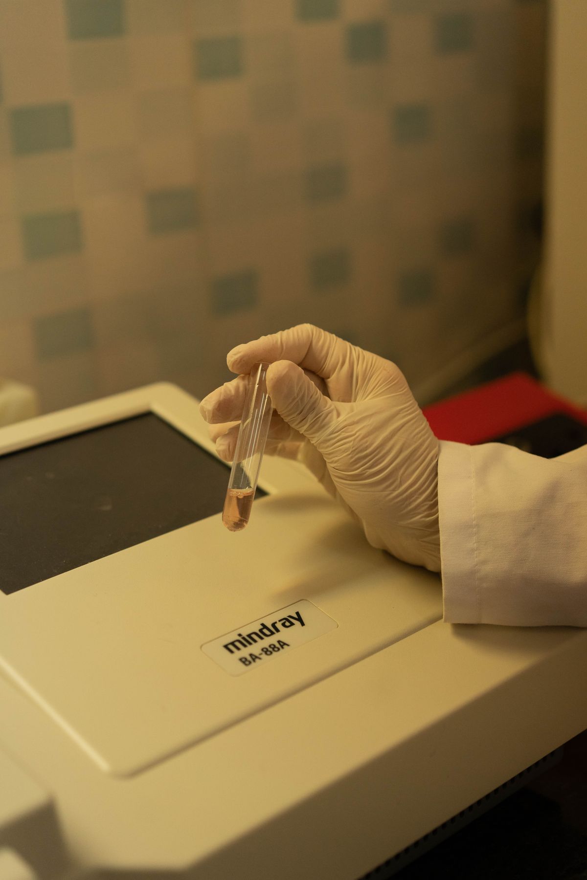 Lab technician holding a sample vial